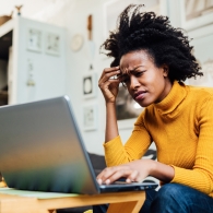Femme frustrée travaillant à domicile sur un ordinateur portable